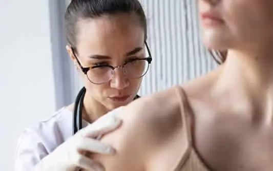 female doctor diagnosing a melanoma